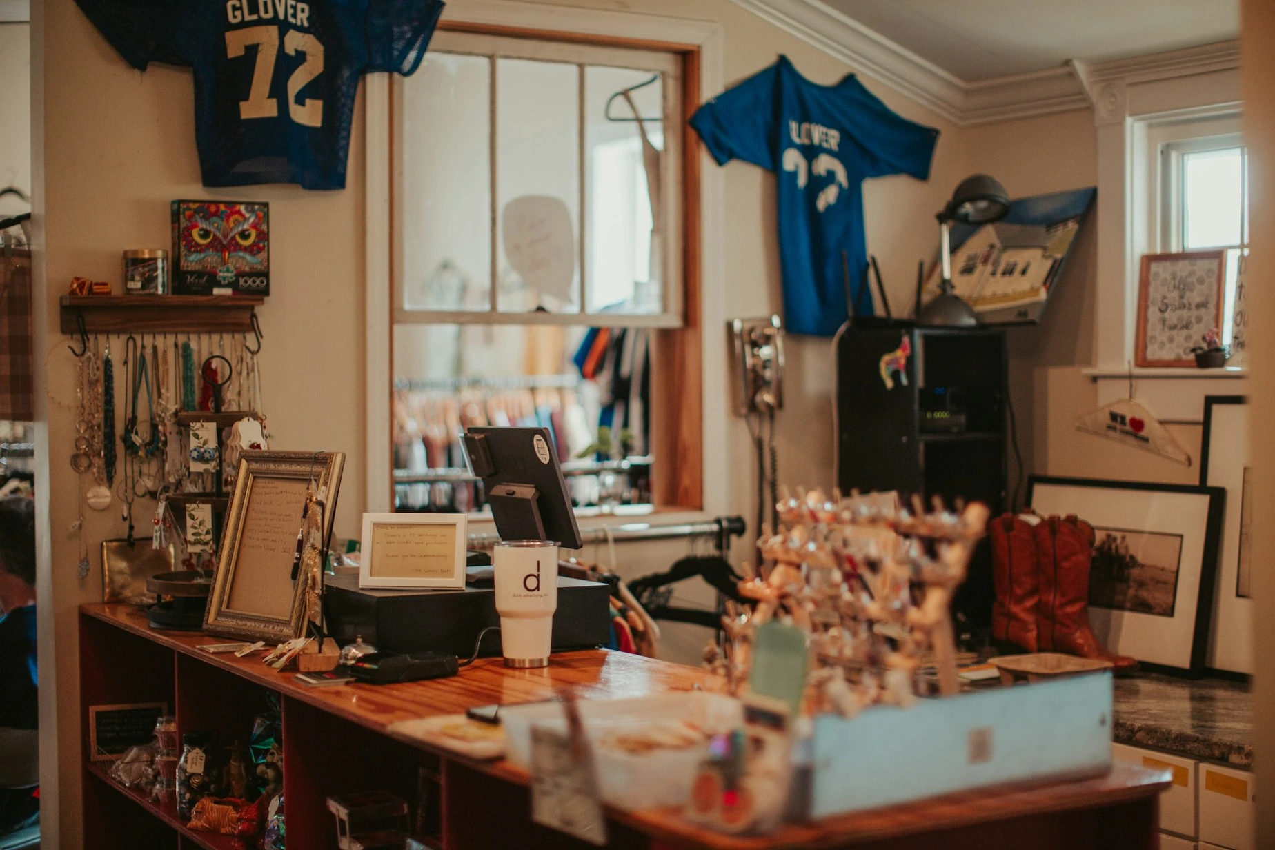 A room with a football jersey hanging on the wall